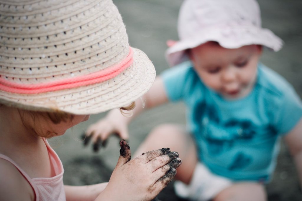 Two children playing in wet sand