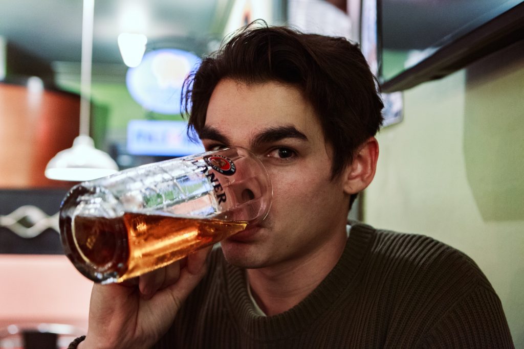 A young man drinking beer