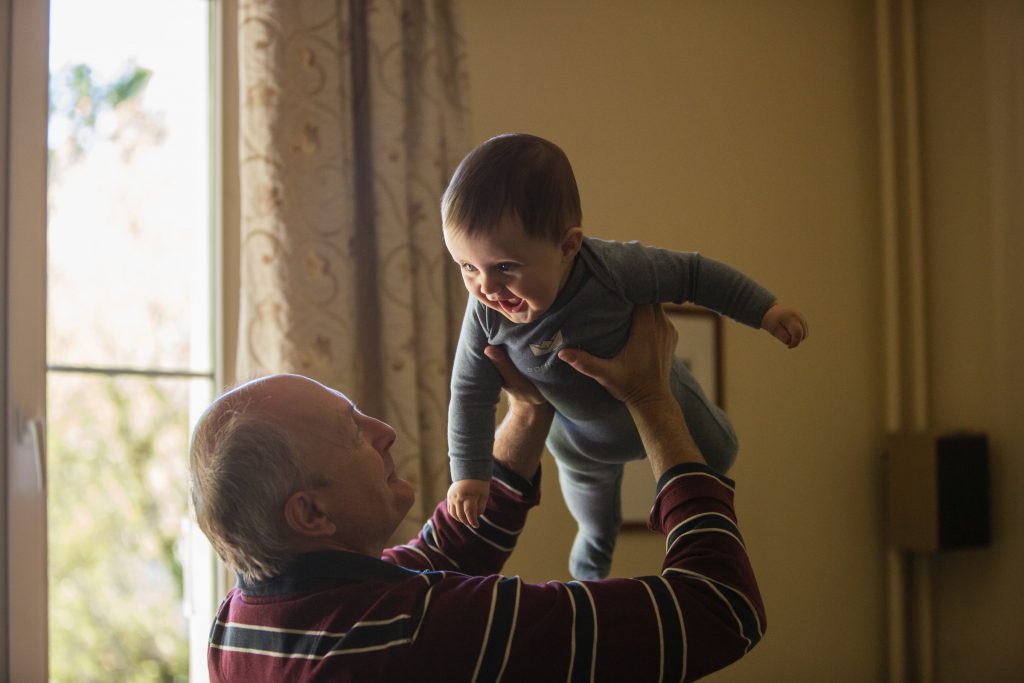 A grandfather playing with his grandson