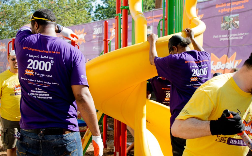 People building a slide in a playground