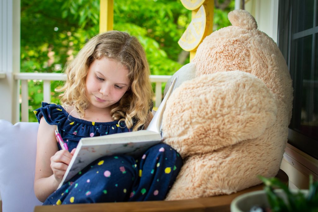 A young girl writing.