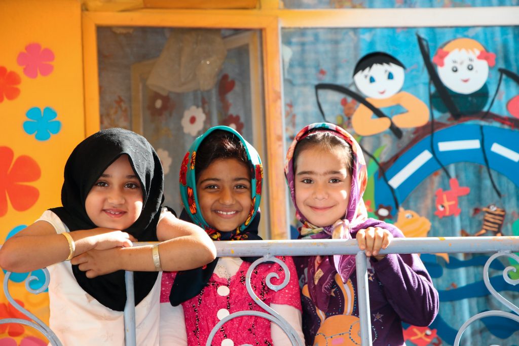 A group of three girls dressed in similar Islamic clothing