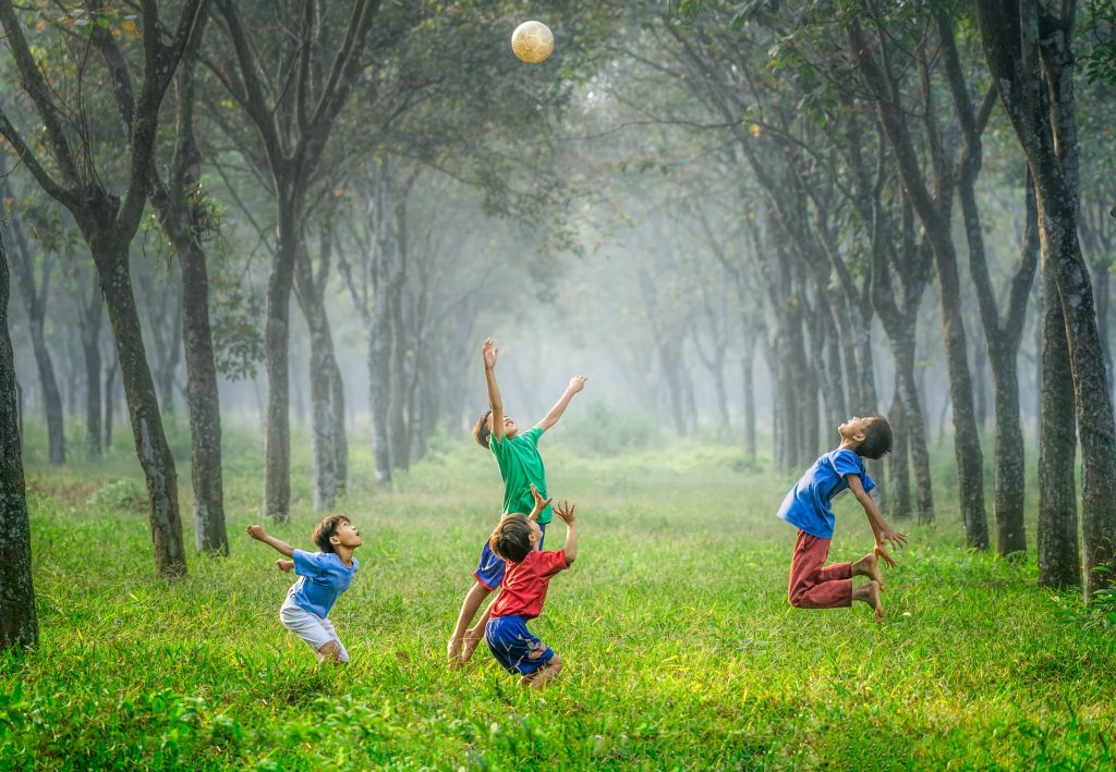 Children playing together with a ball