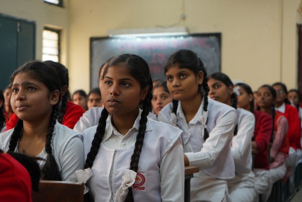 Young female students sitting in a classroom