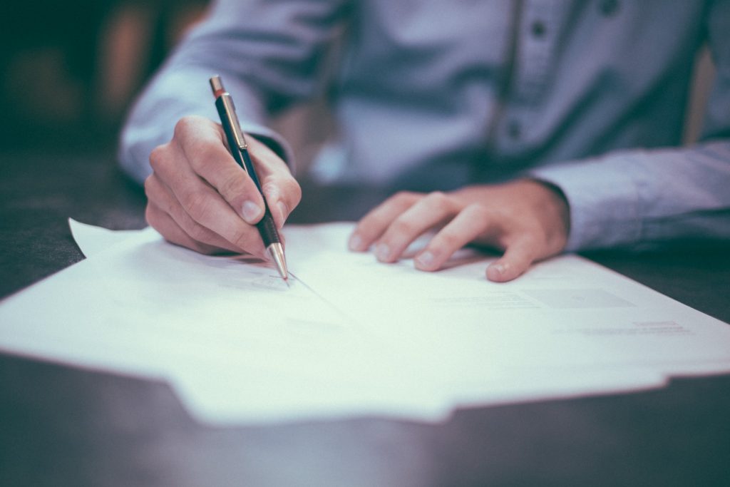 A man recording research data with a pen and paper