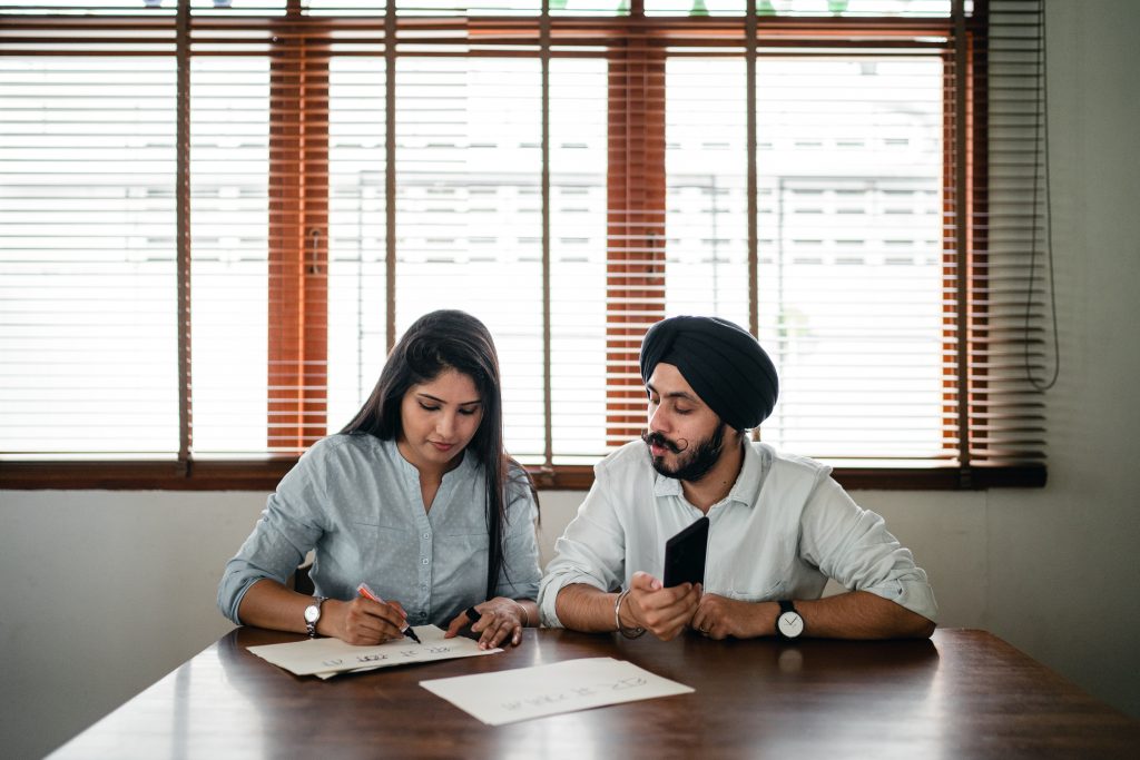 A student works with a tutor at a table. 