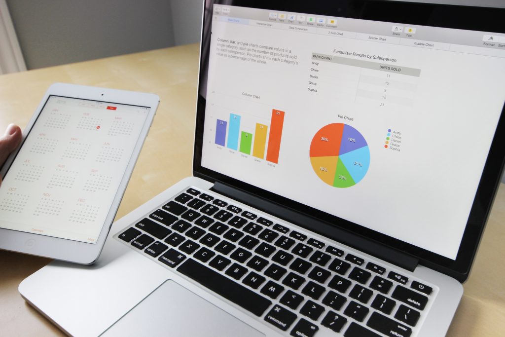 Laptop screen shows two examples of graphs: bar graphs and pie charts.