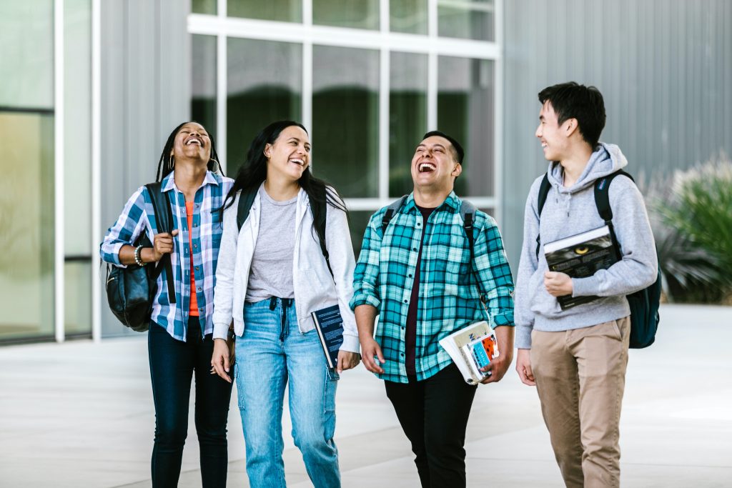 Diverse classmates talking to each other after studies.