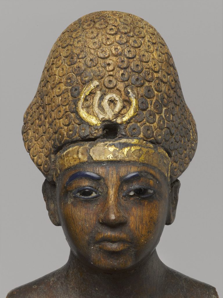 Wood, gold leaf, glass, pigment Egyptian statuette.