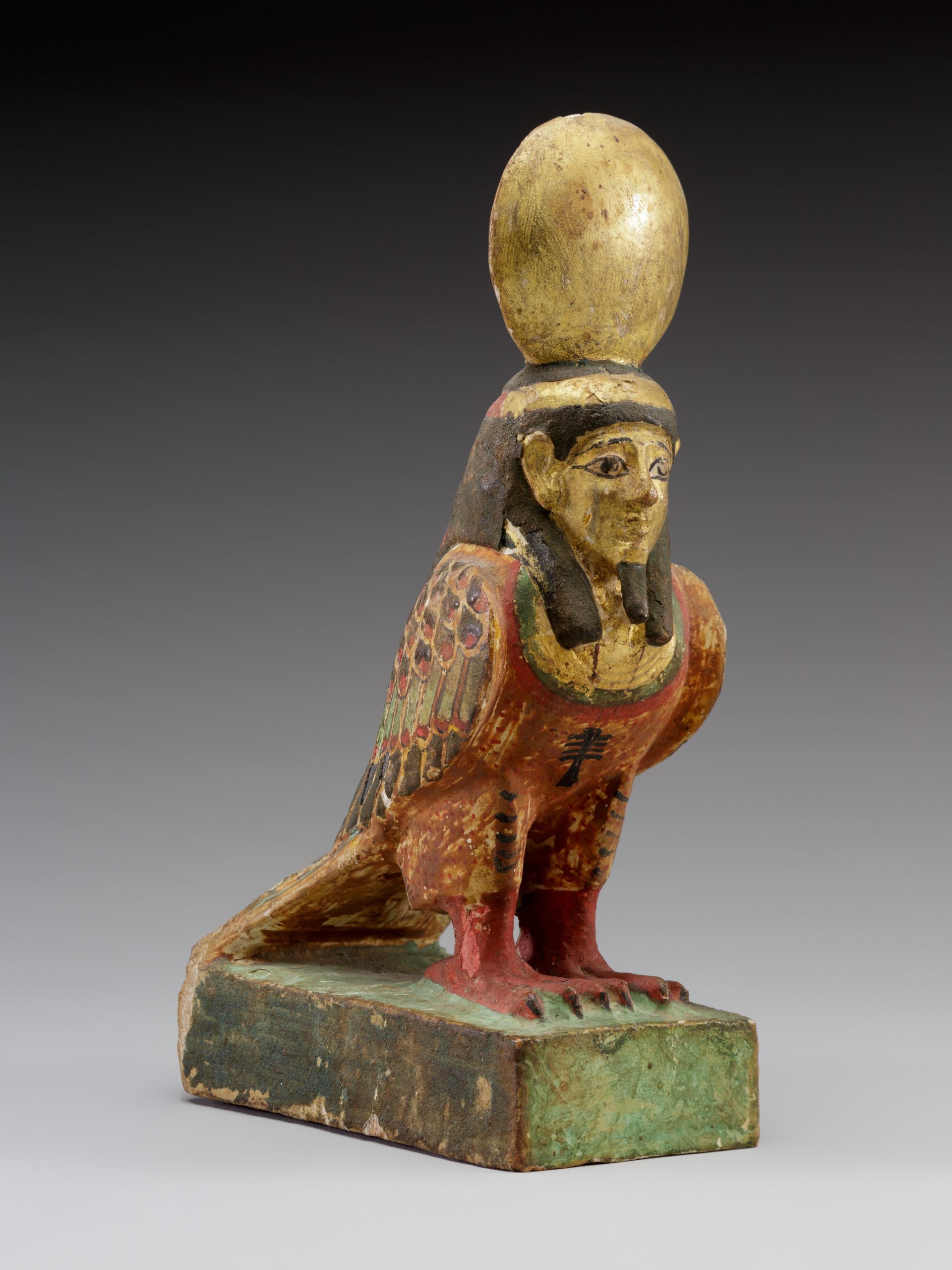 A statuette of an Egyptian Ba-Bird with a gold egg sitting atop the pharaoh head.