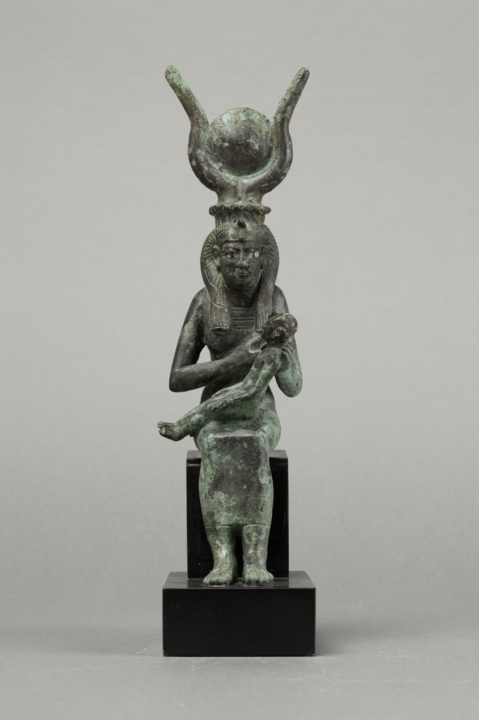 A statuette of Goddess Isis holding Horus.