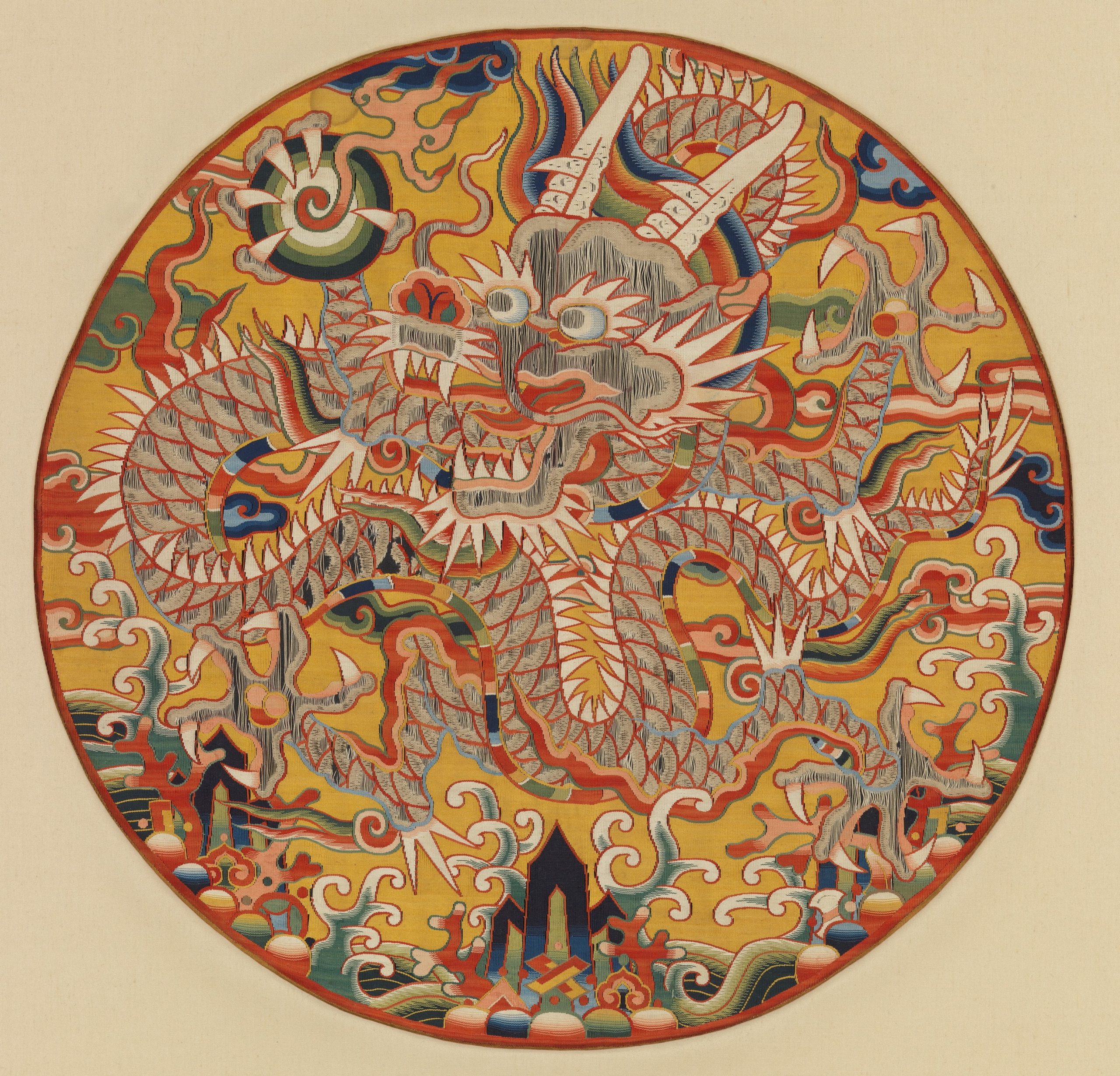A dragon is surrounded by a variety of shapes and patterns inside of a circle.