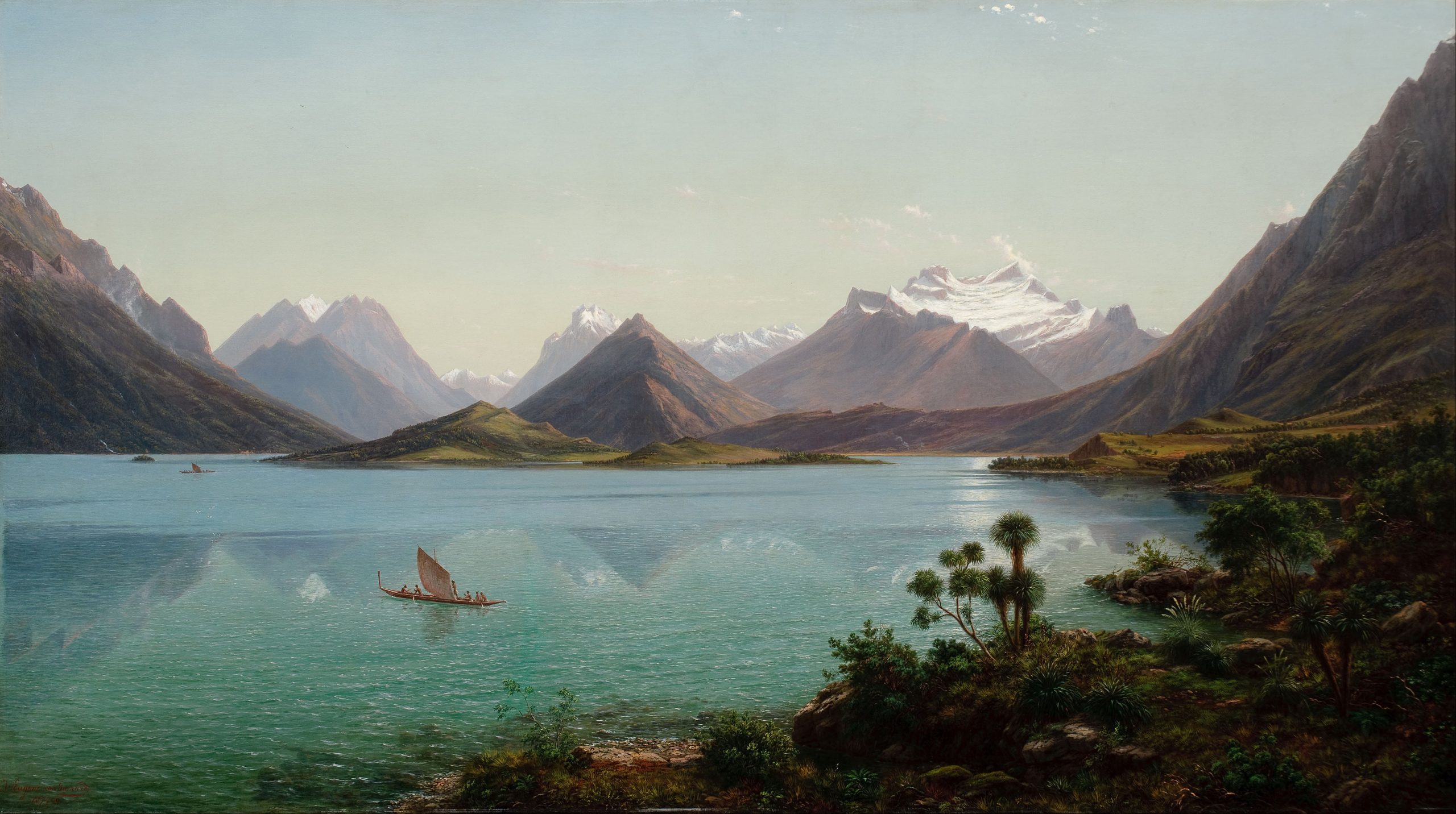 A landscape view of a calm lake with snowy mountains in the background