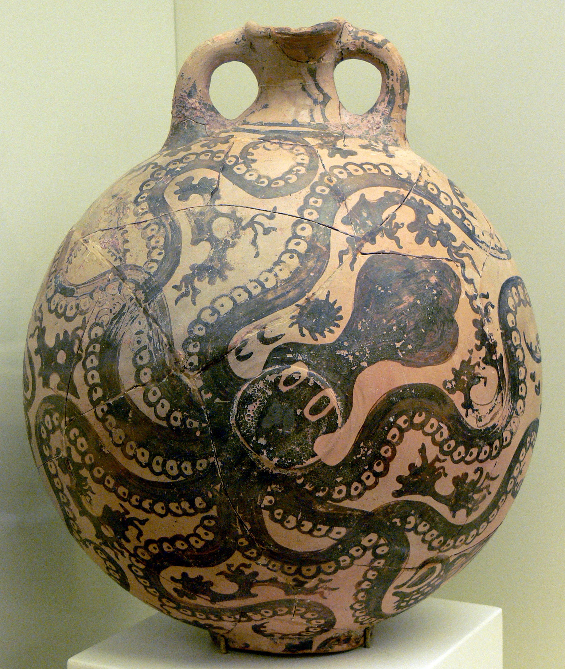 An octopus with other sea elements painted on a round clay vessel