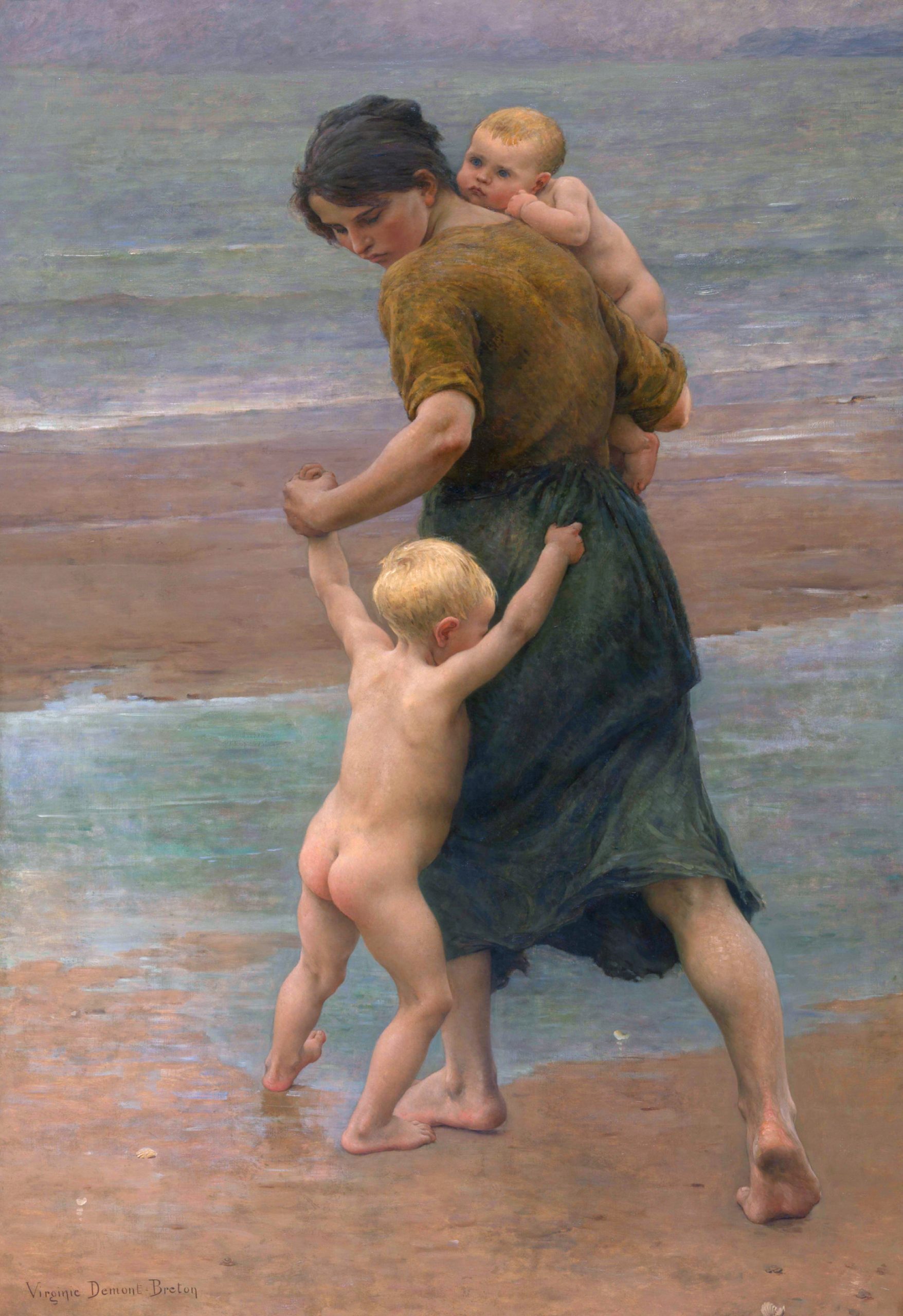 A woman carrying a baby in her arm and holding a toddler by the hand while striding across the beach