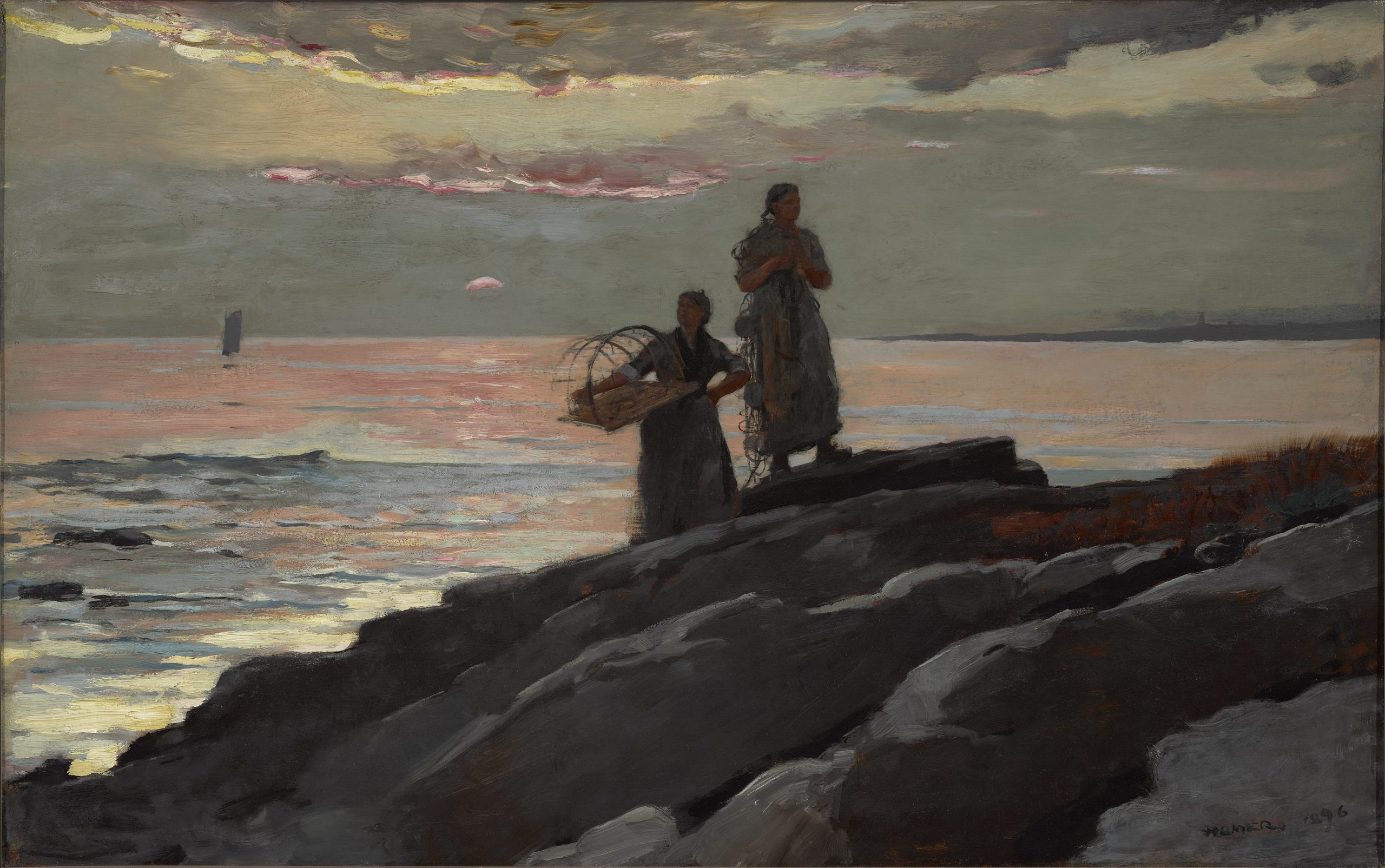 Two women carrying fishing equipment observing their surroundings on a rocky shoreline at sunset