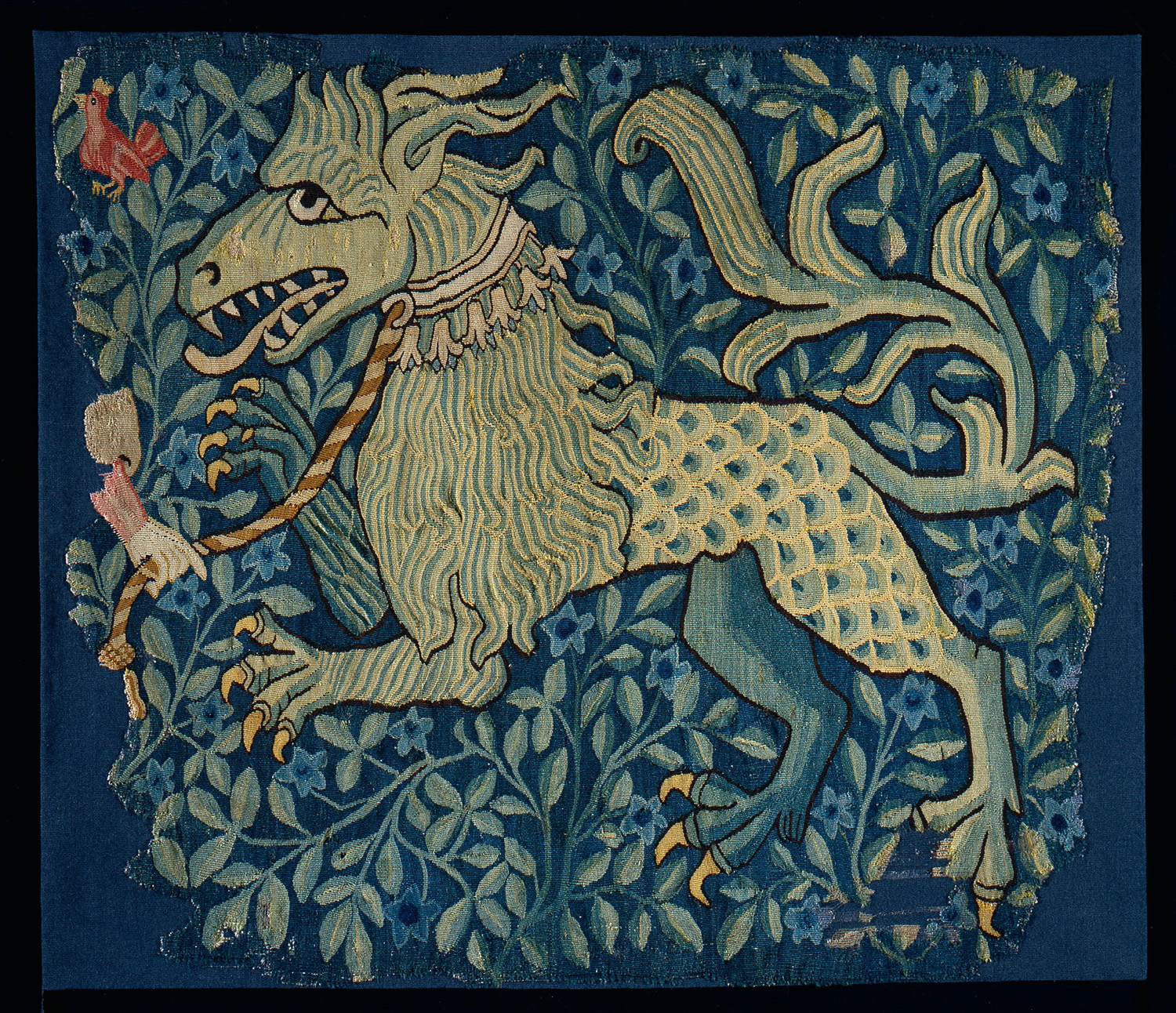 A tapestry details the image of a hybrid animal creature featuring claws, scales, a tail and a lion's mane.