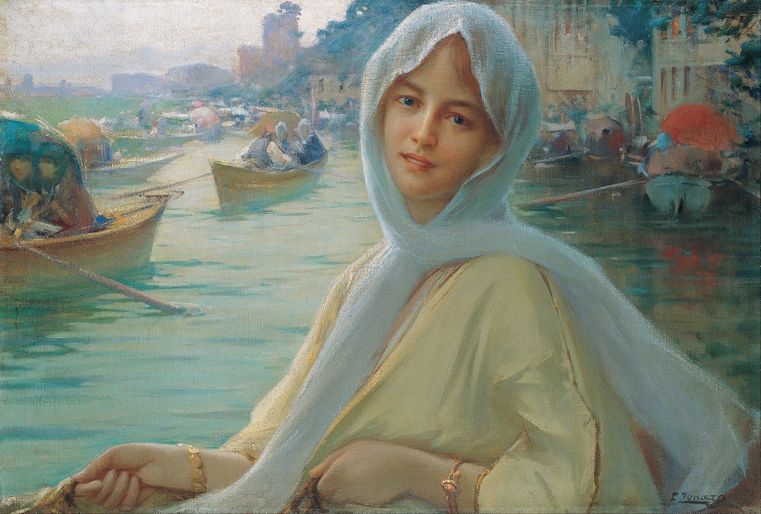 A young girl with a headscarf smiling back at the viewer with a view of a water canal in the background