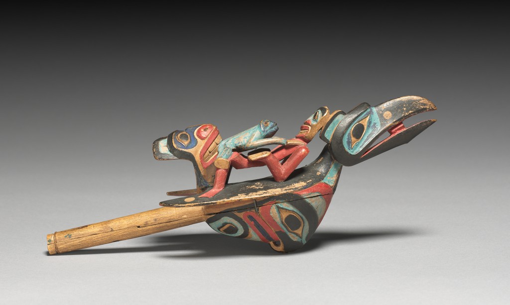 A wooden rattle depicts several animals together.