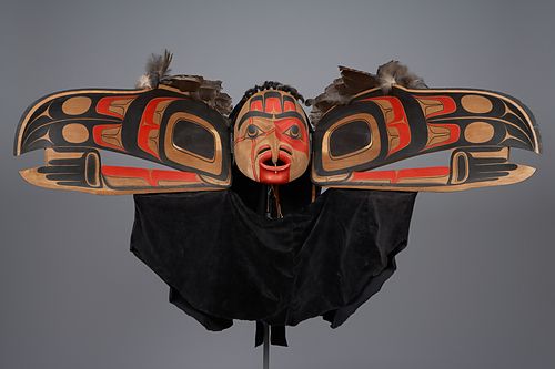 A large mask details the transformation of a raven.