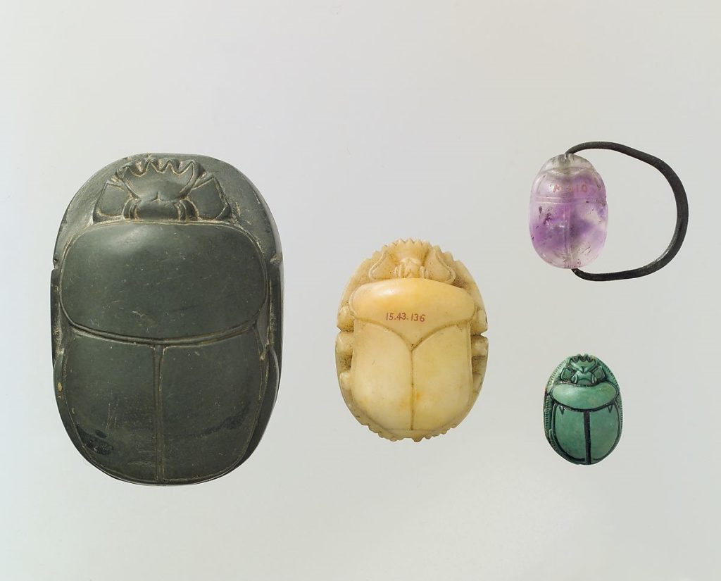 An array of large and small colourful scarabs ranging from green, yellow, and violet.
