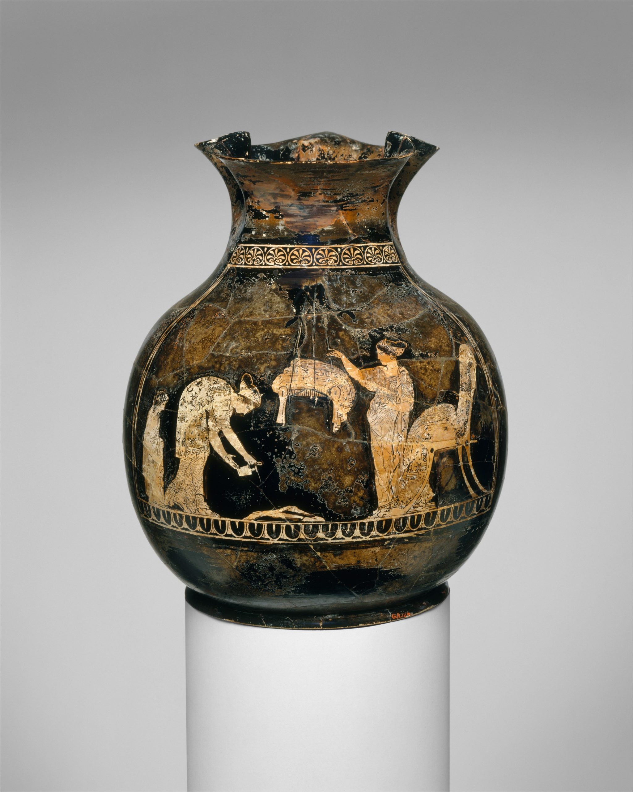 A terra cotta-red vase decorated with figures of women and animals.