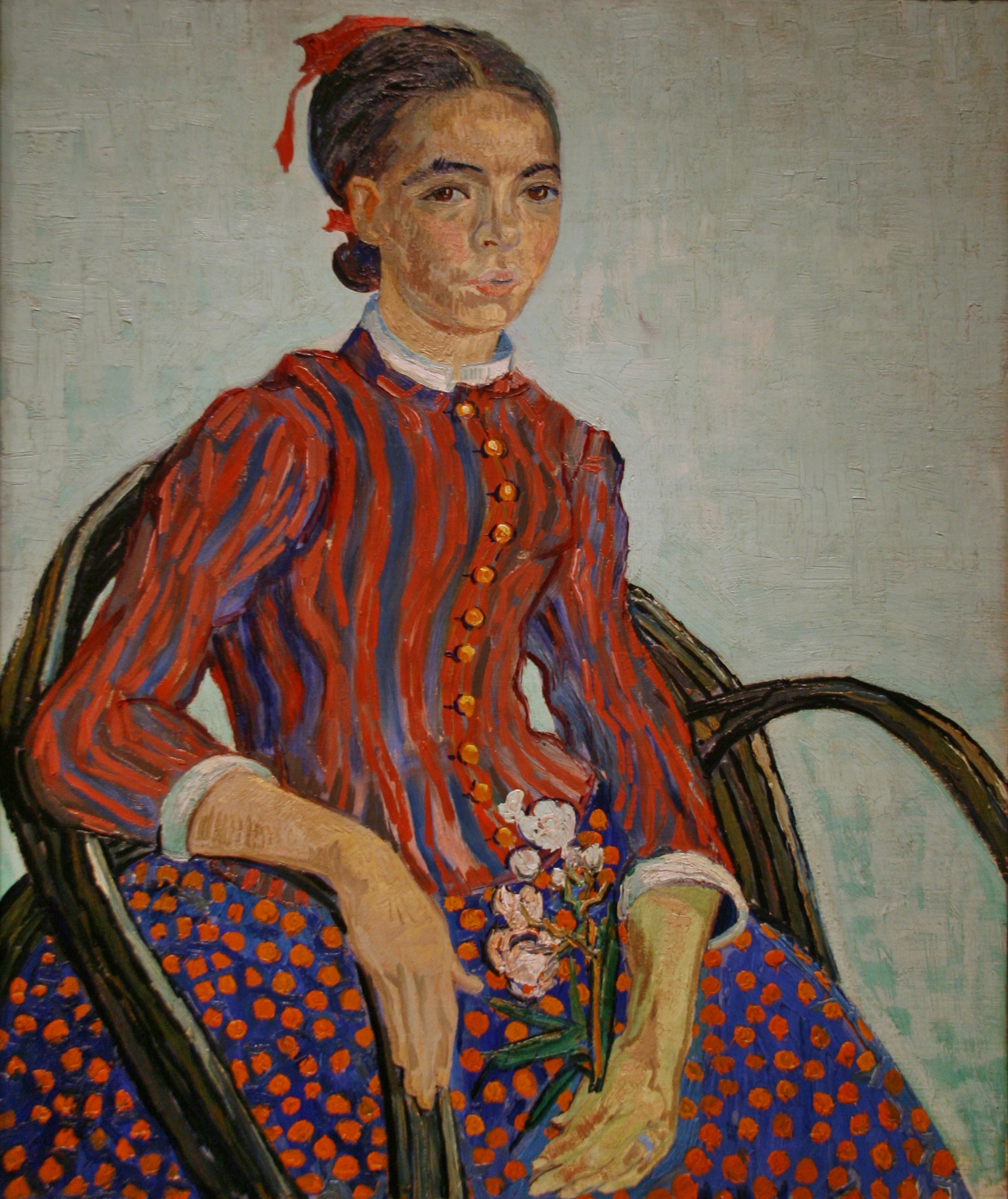 A portrait of a girl seated on a chair