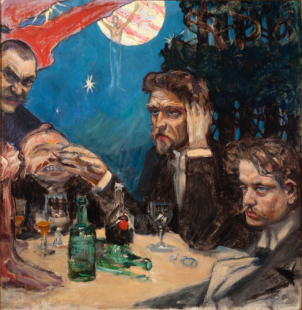 A group of men look dazed and sit around a long table filled with drinks.