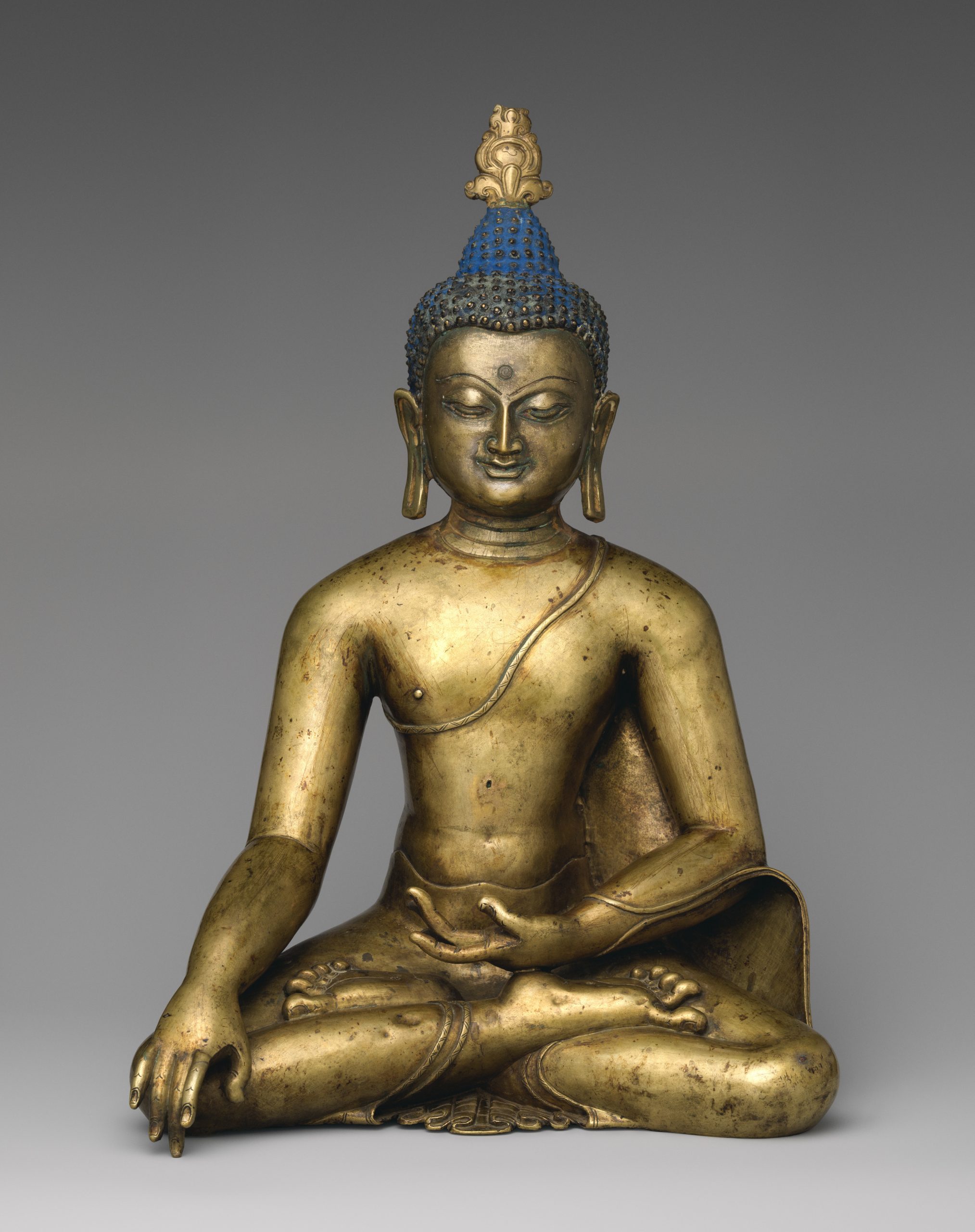 A photograph of a sculpture of a buddha from 12th century Tibet