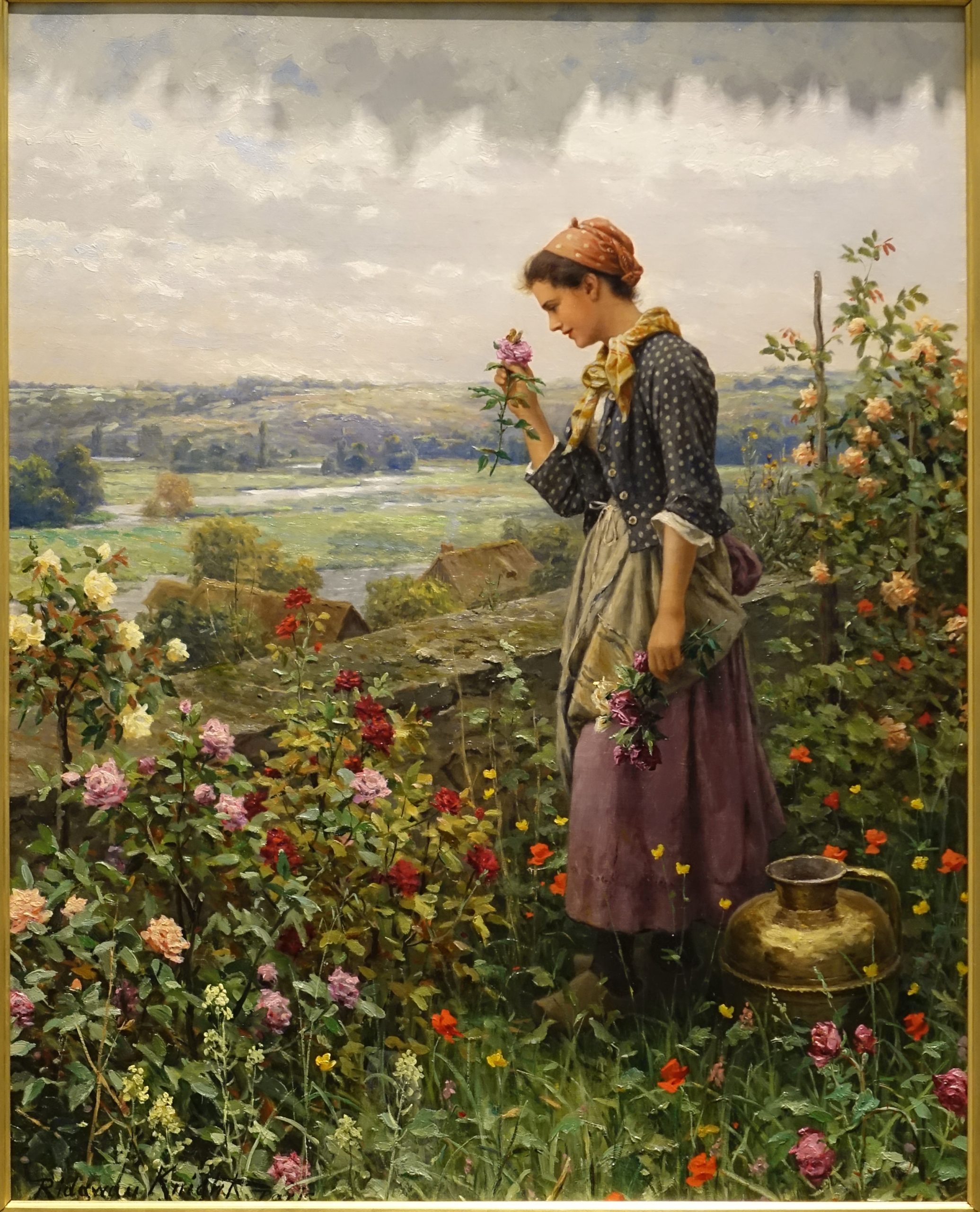 A woman admiring a flower in a garden as a storm brews in the sky