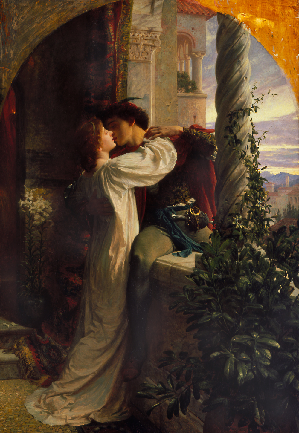 A man seated on the ledge of a castle balcony leaning in to kiss a woman