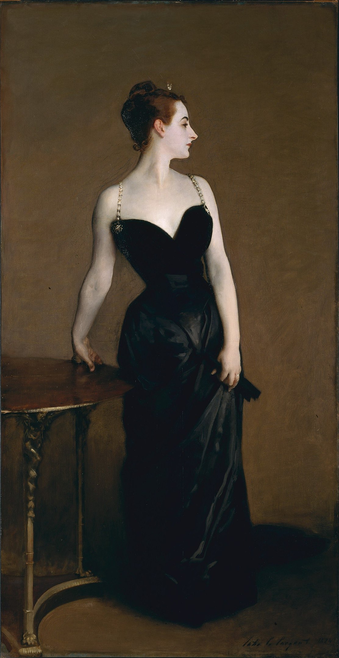 A portrait of a woman in a long black dress with her right hand placed on a table.
