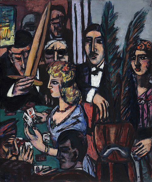 A woman seated at a table holding playing cards with other figures watching her