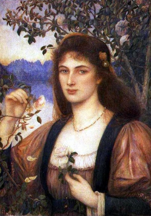 A portrait of a young woman who holds flowers in her hands and stands against a backdrop of mountains and water.