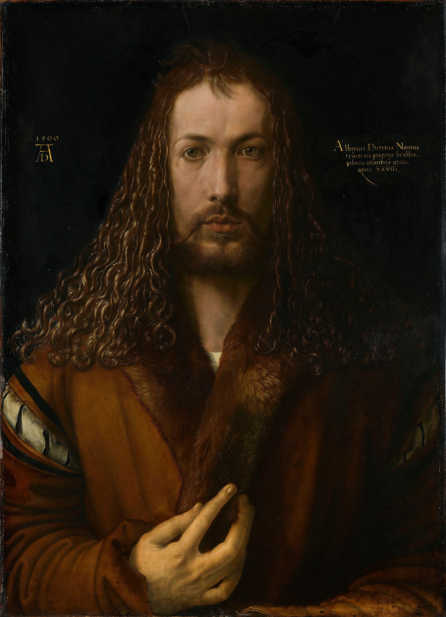 A portrait of a man with his fingers brushing lightly over his fur jacket