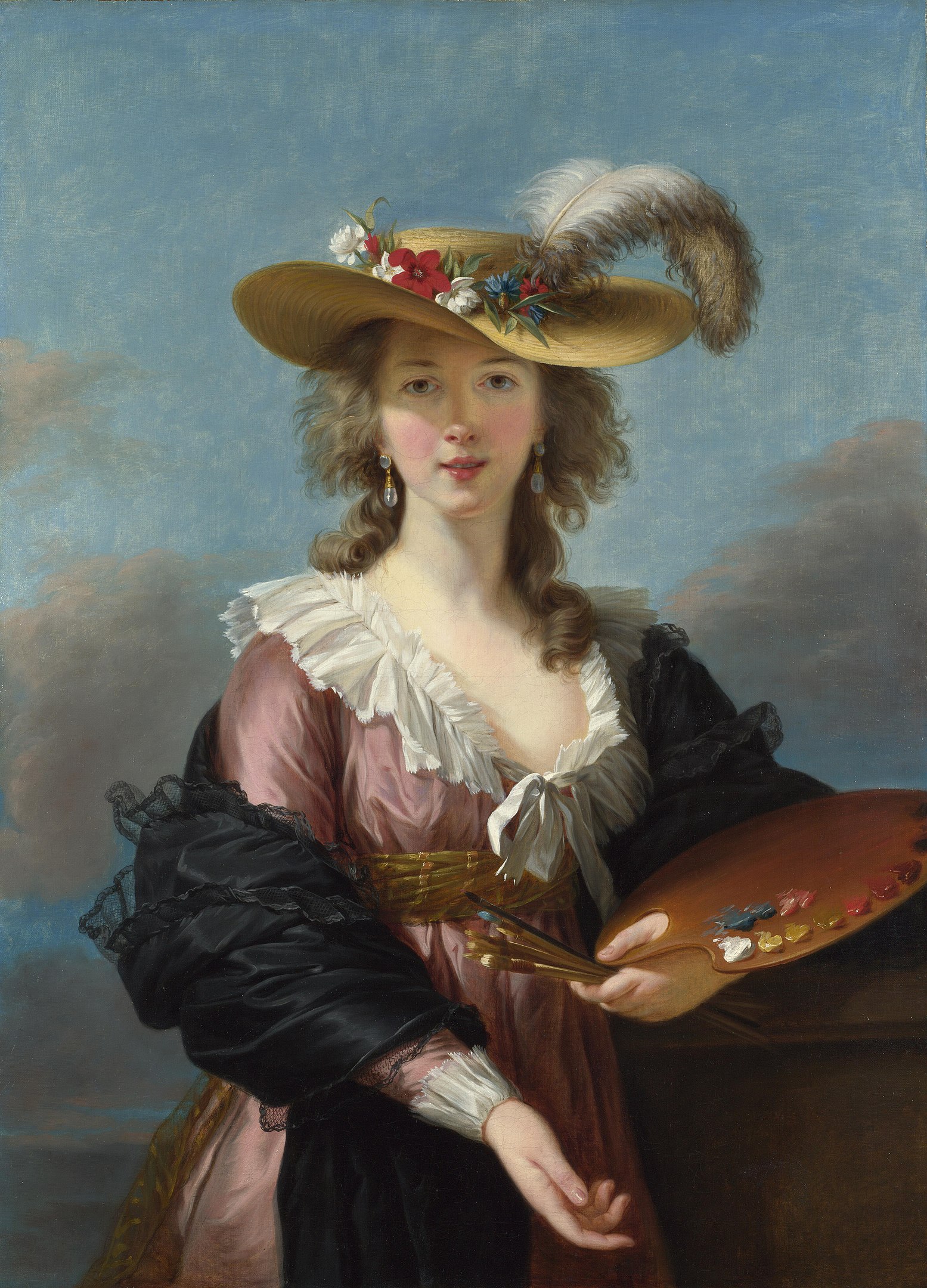 A portrait of a woman with paintbrushes and a palette in her hand looking back at the viewer