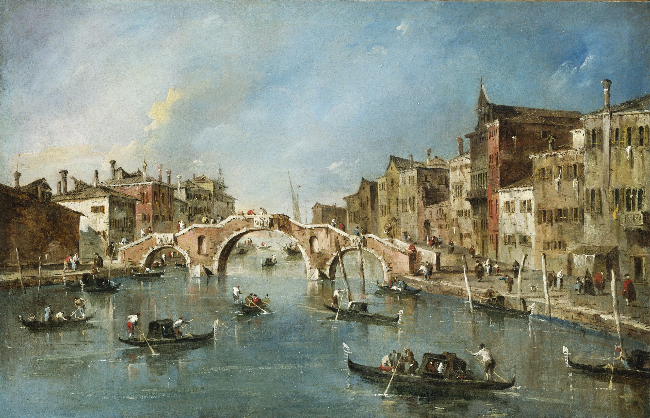 A landscape view of boats on a canal in a city