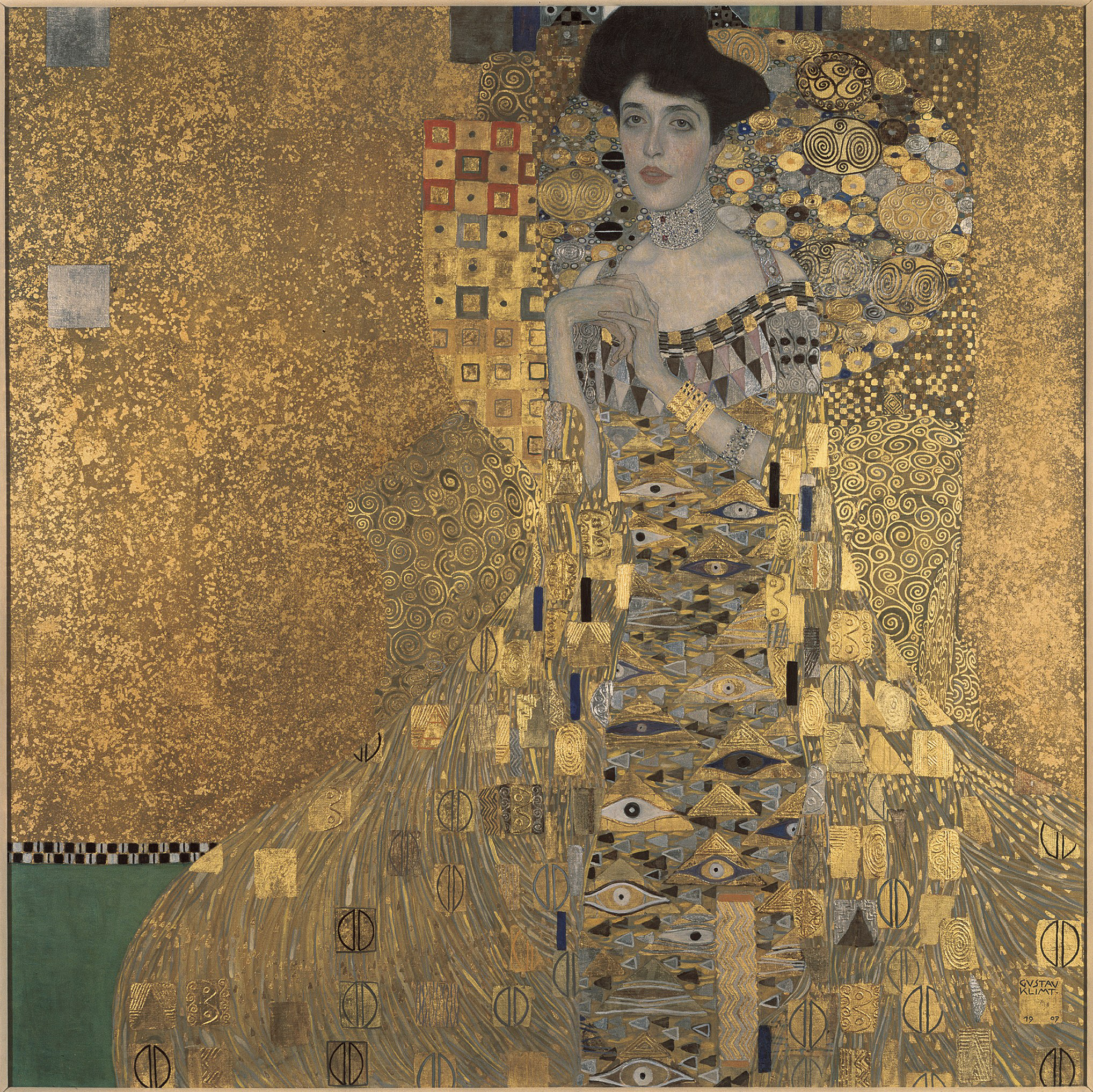 A woman wearing jewelry and a gold dress
