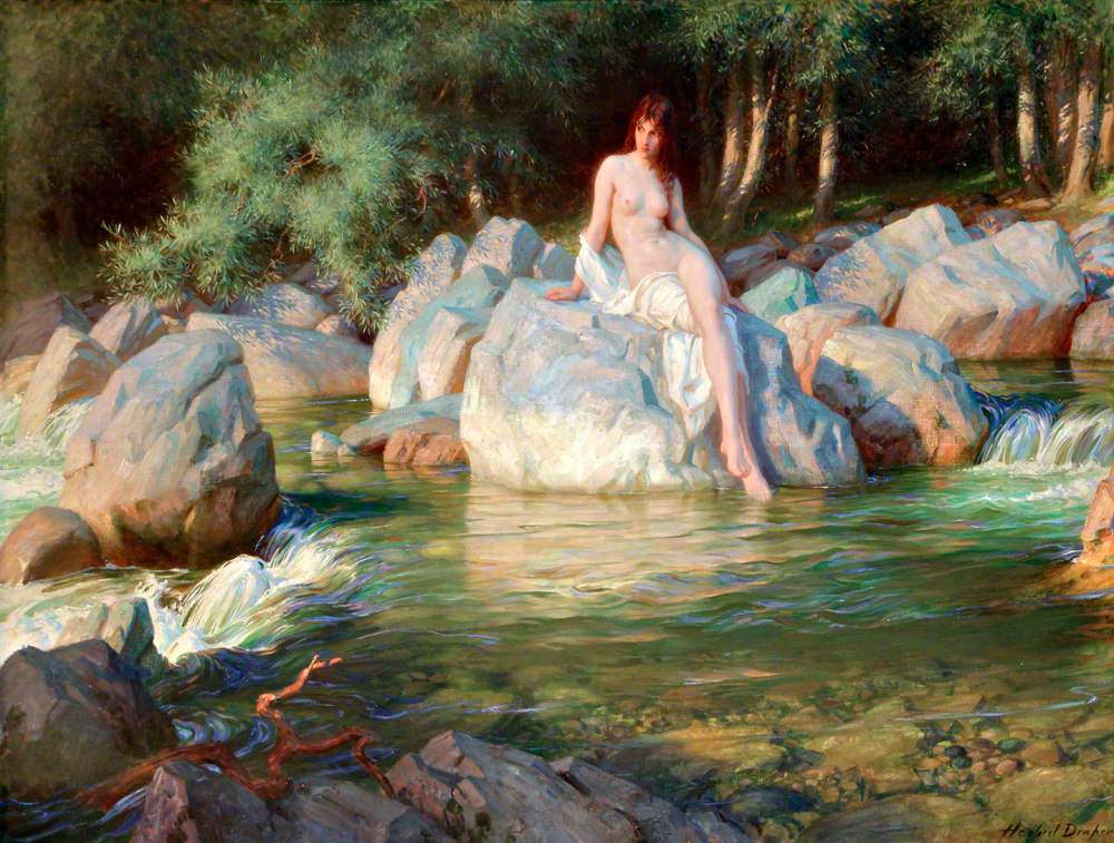 A nude woman sitting on a rock beside a stream in a forest