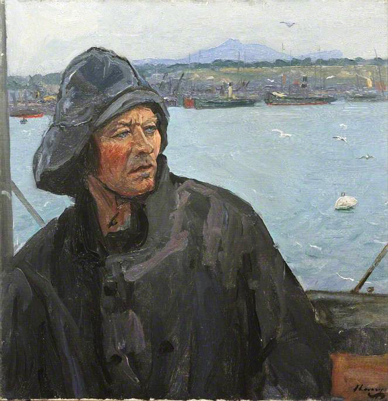 A seafarer on a boat looking to his left with a view of the dock behind him