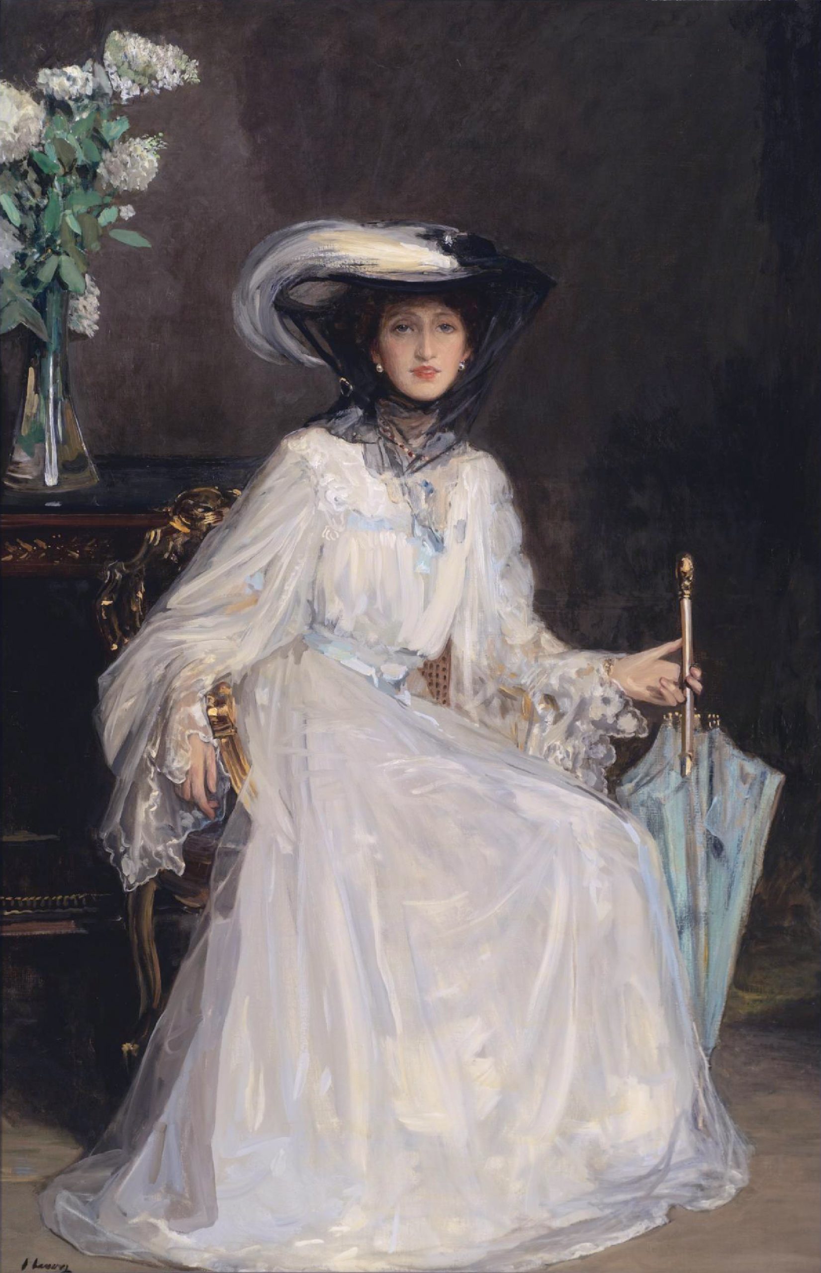 A full-body portrait of a seated woman in a dress holding a closed umbrella