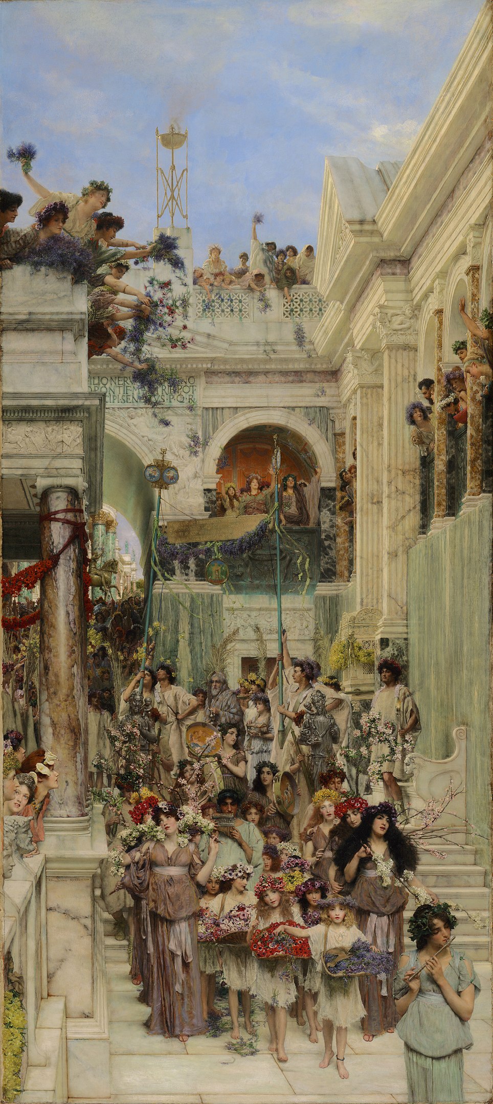 A procession of people walking through a classical courtyard with people celebrating