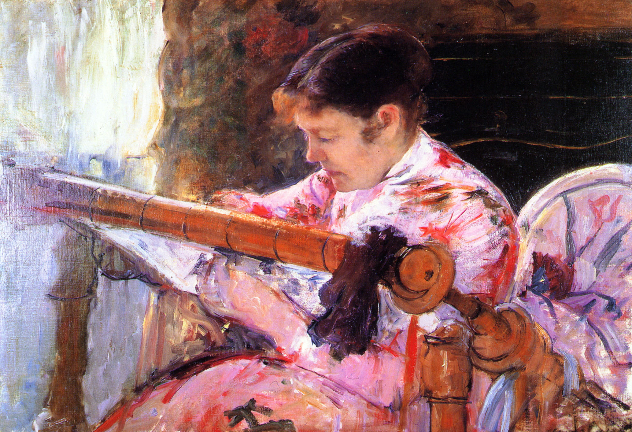 A woman working a tapestry loom