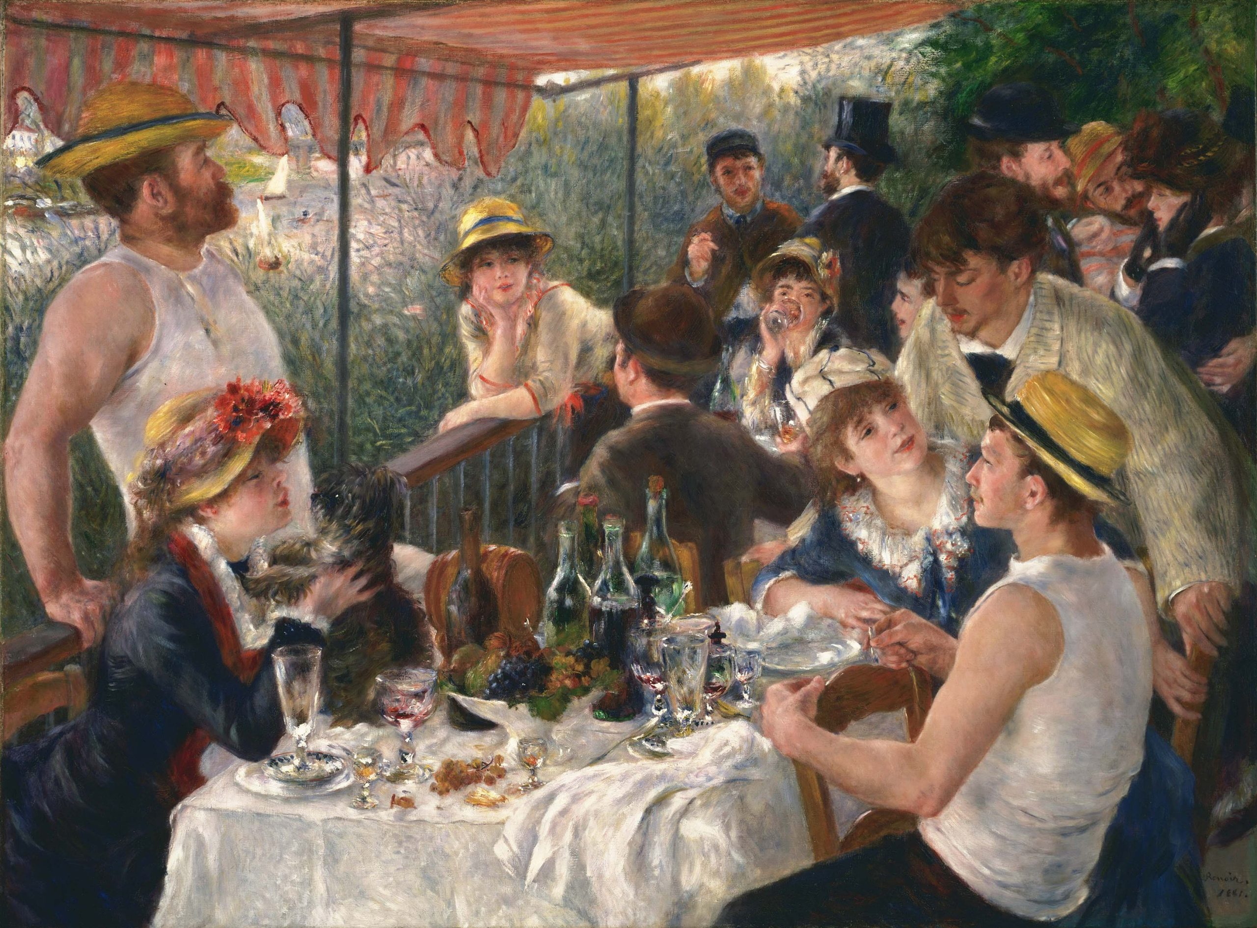 Men and women gathered around a table outdoors for lunch