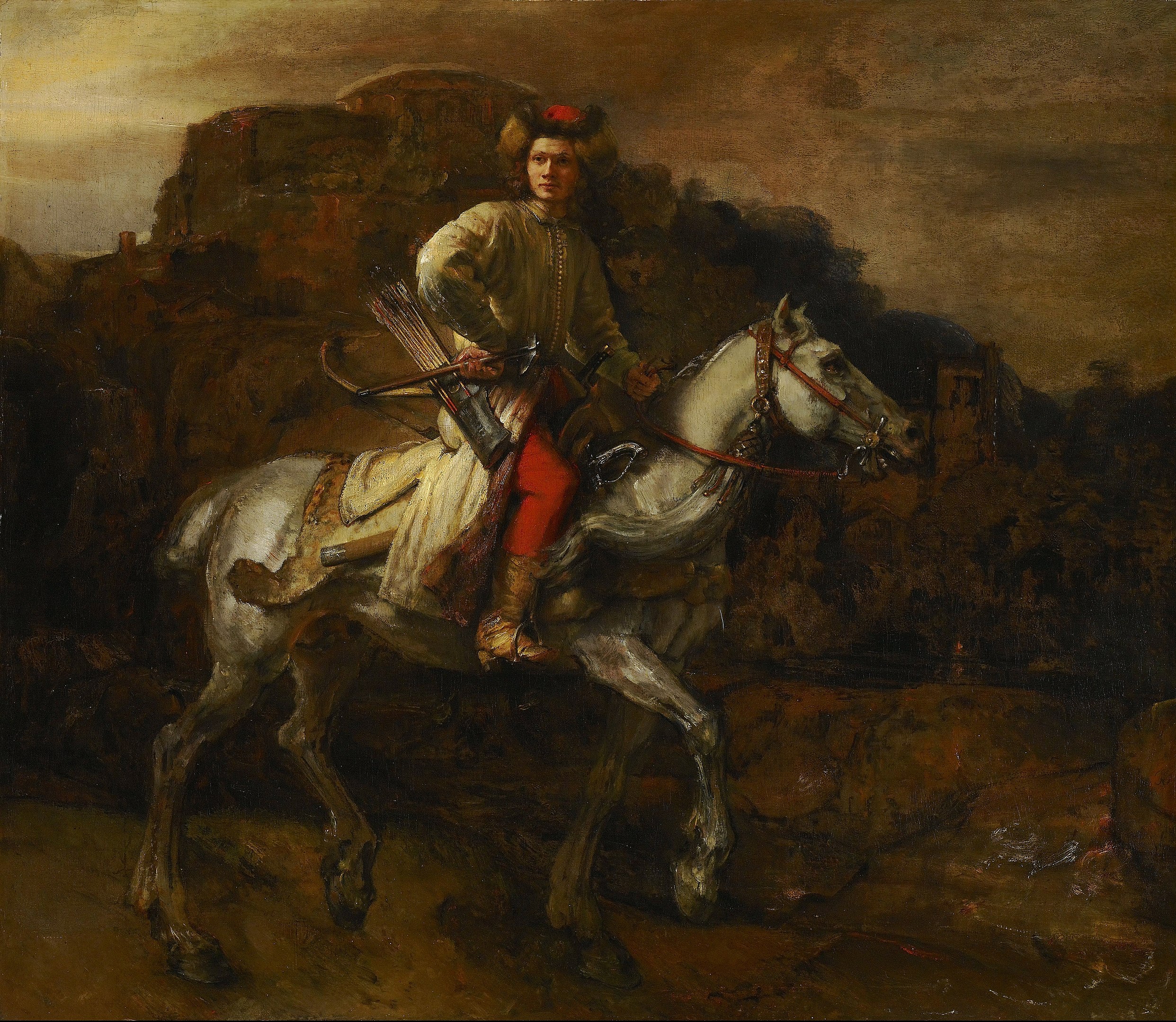 A man riding a horse in a dark landscape