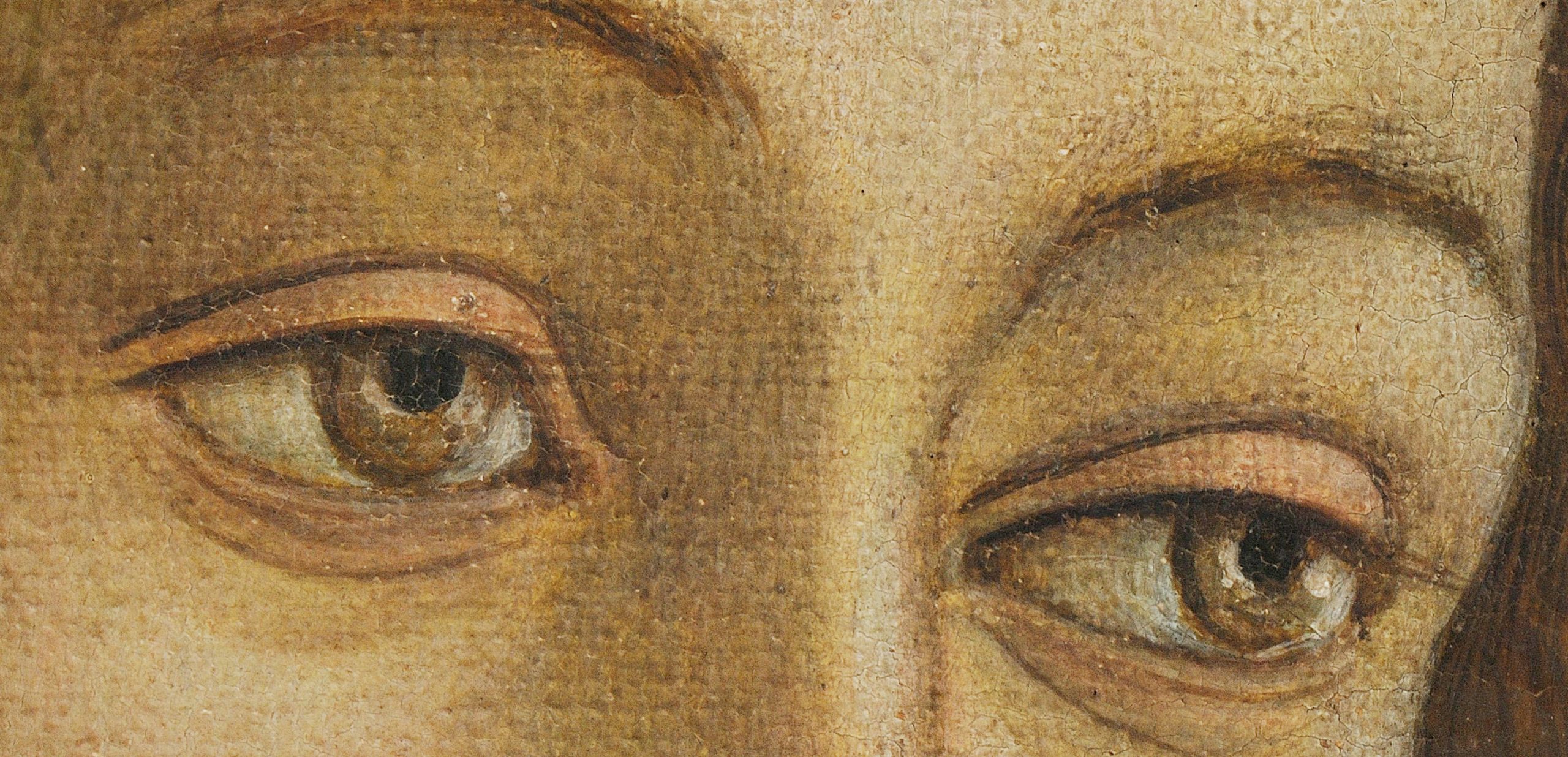 A closeup of a woman's eyes staring away