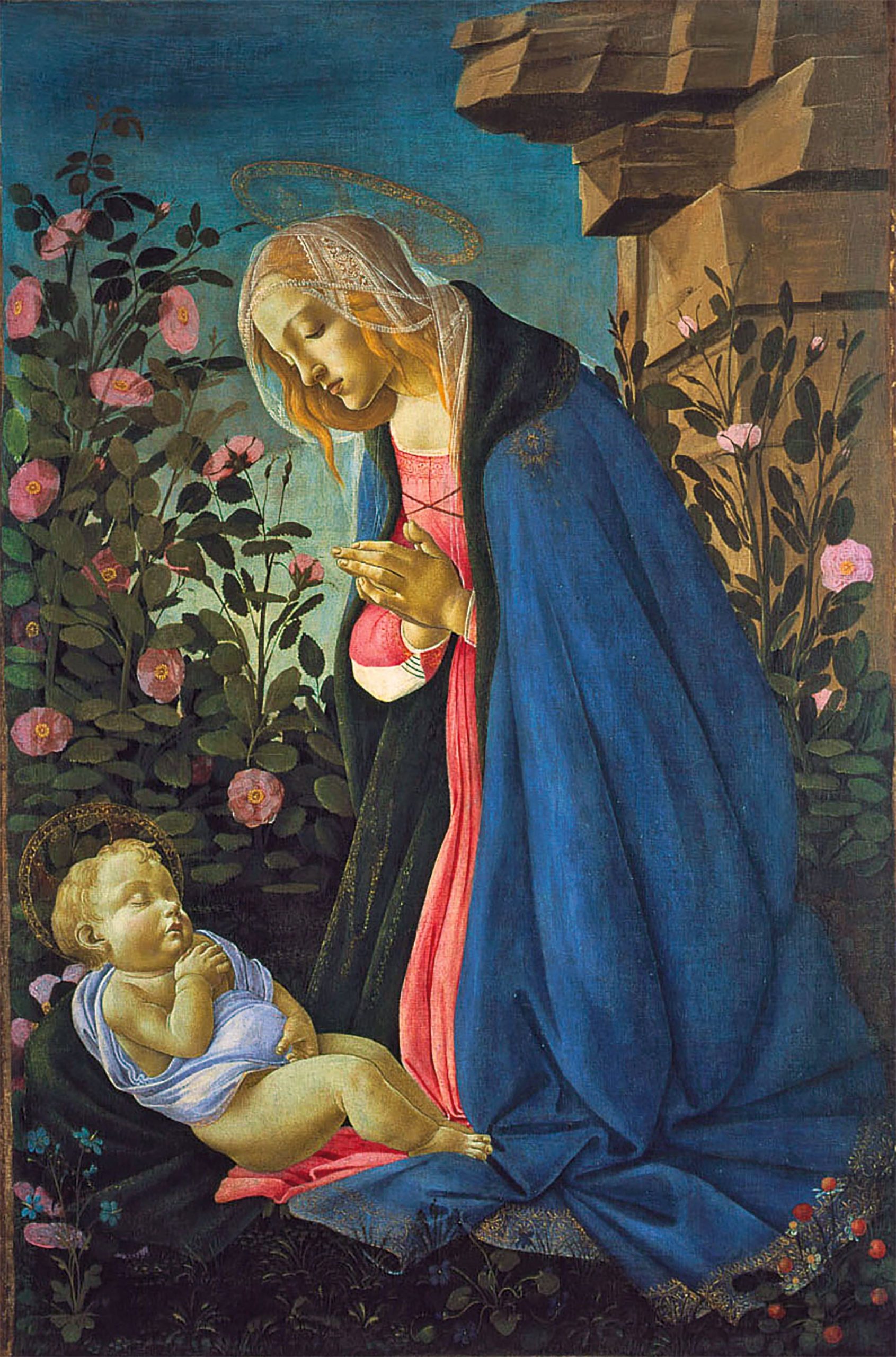 A woman with a halo kneeling and praying to a sleeping infant in a garden