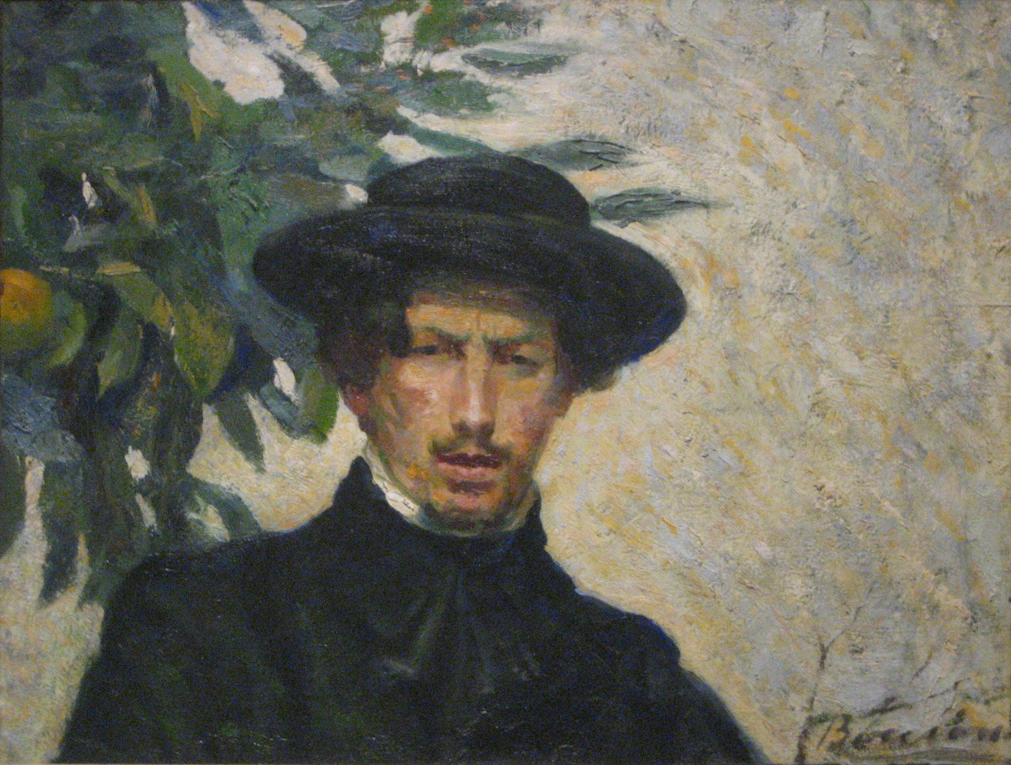 A portrait of a man in a hat staring back at the viewer