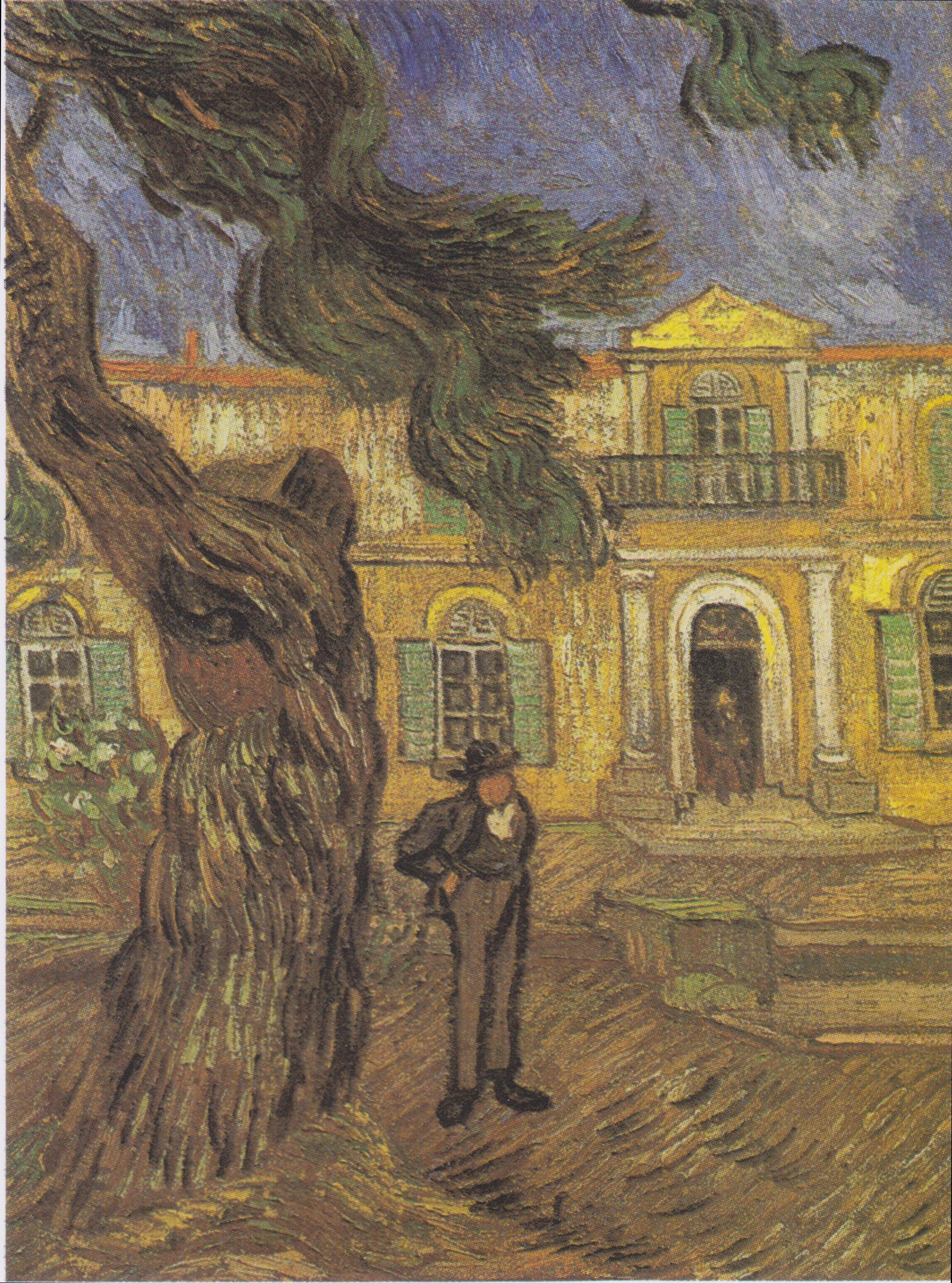 A man in a suit standing by a large tree near a manor