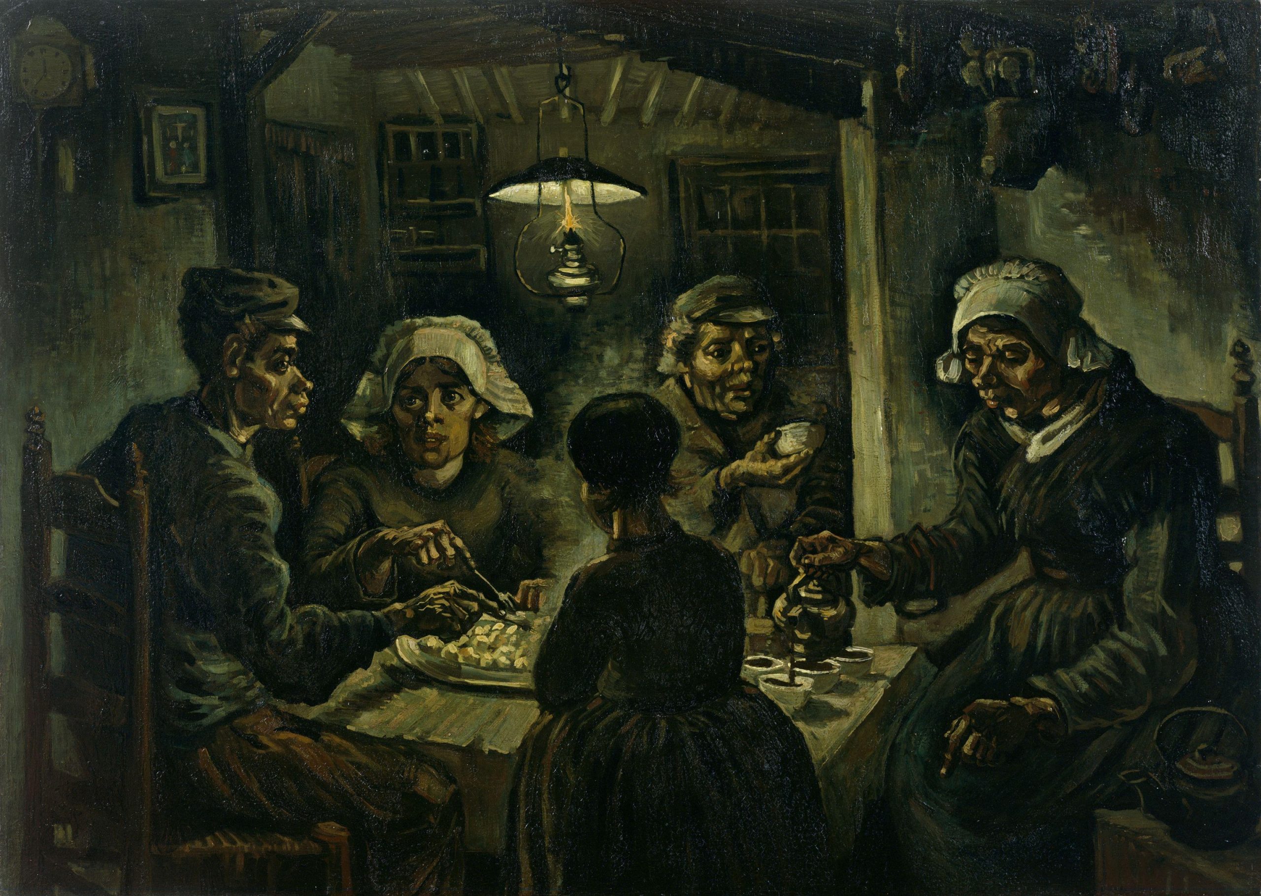 Peasants having a meal at a table in a dark room